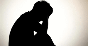A man sitting down in regret