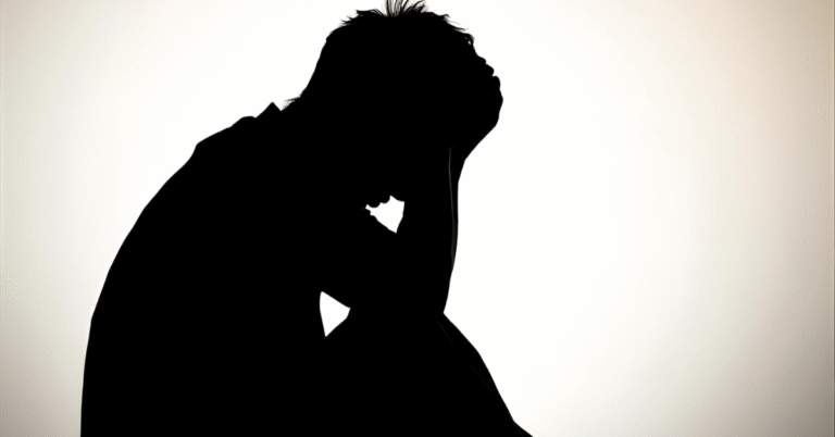 A man sitting down in regret