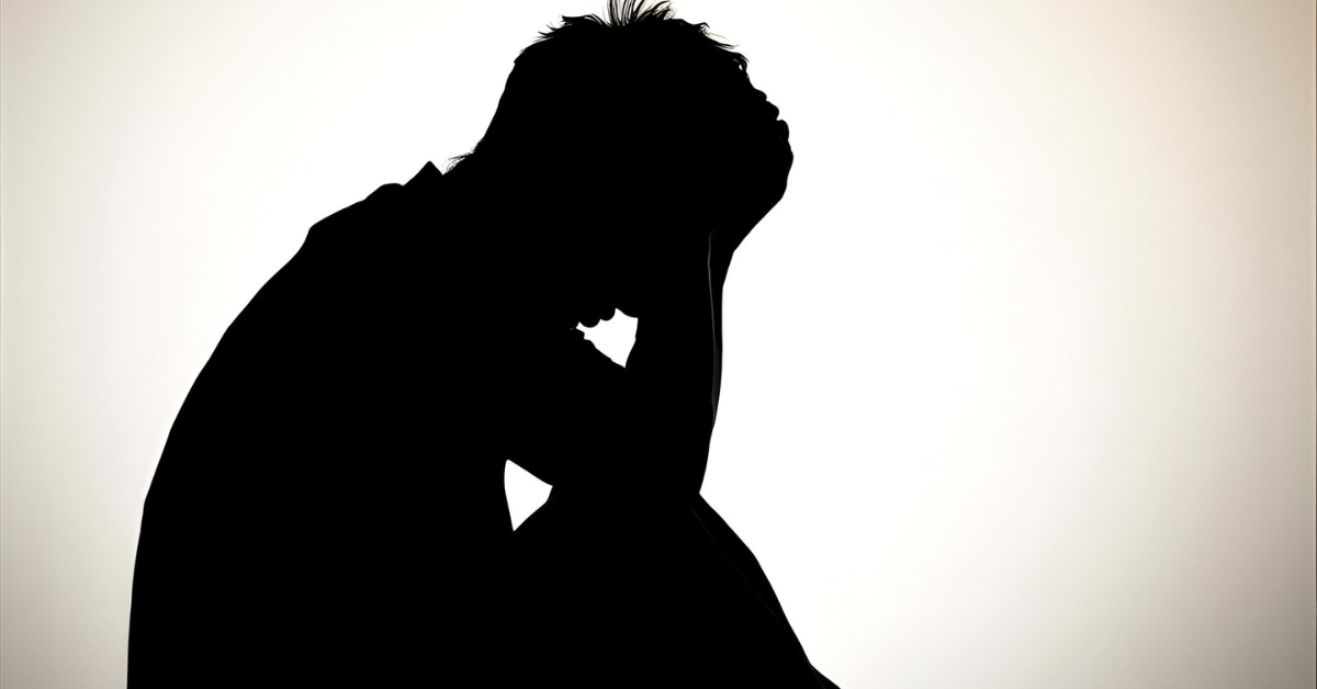 A man sitting down in regret