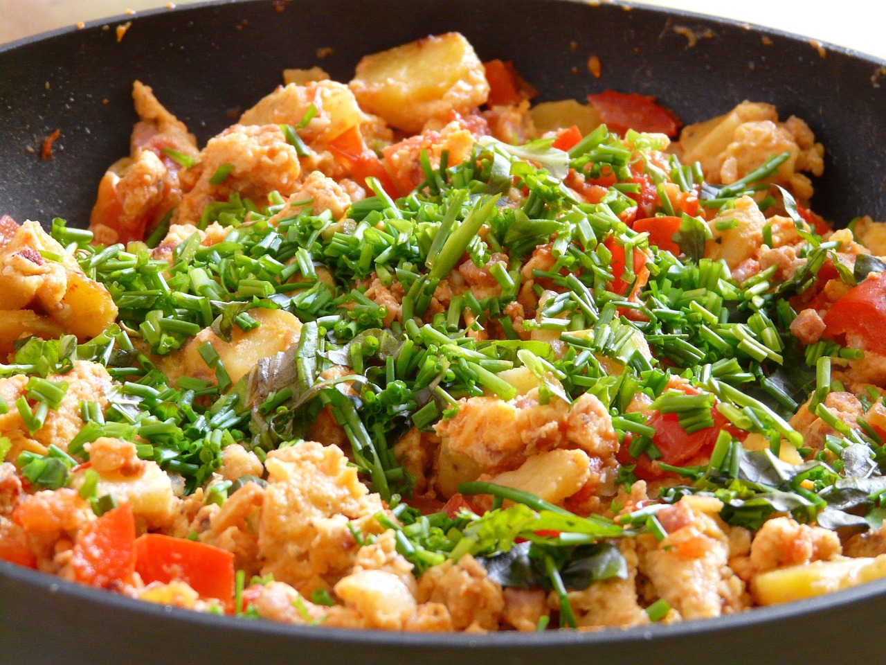 > Quick weeknight dinner idea — colorful chicken stir-fry with vegetables in a skillet served with rice.